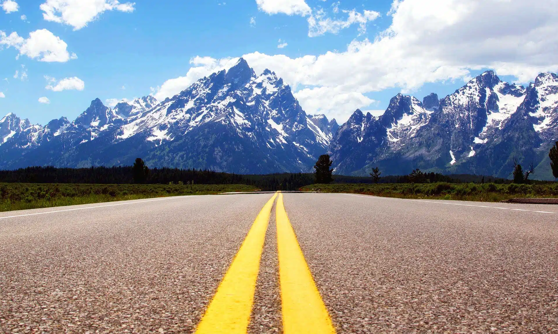 Long Road Headed towards Snowy Mountains